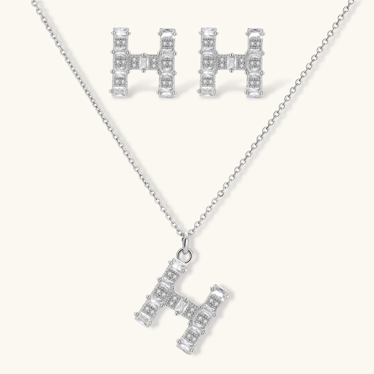 Letter H jewelry set featuring geometric crystal design in gold and white gold plated finish with adjustable chain necklace