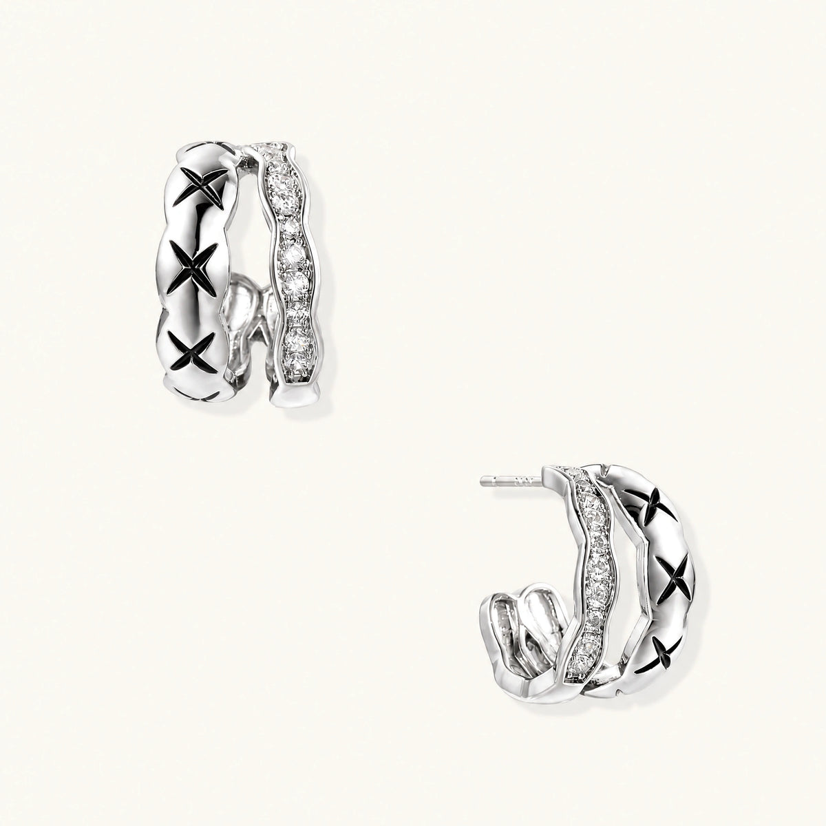 Triple-row white gold hoops with black X-pattern, twisted band, and pavé zirconia stones on white background.