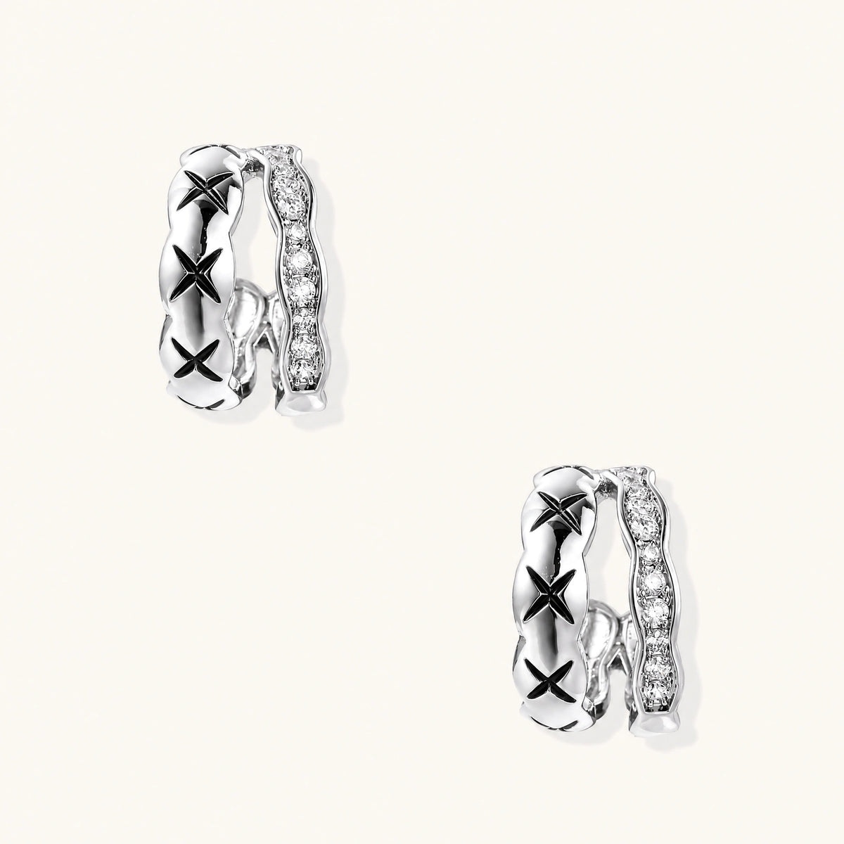 Triple-row white gold hoops with black X-pattern, twisted band, and pavé zirconia stones on white background.