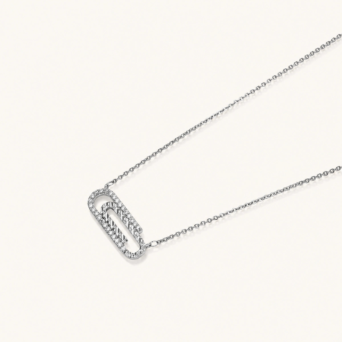 White gold plated necklace with dual-frame geometric pendant featuring crystal pavé border on pale background.