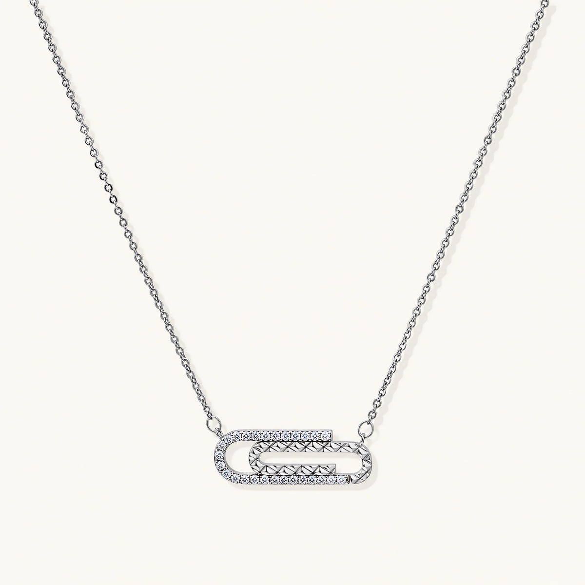White gold plated necklace with dual-frame geometric pendant featuring crystal pavé border on pale background.